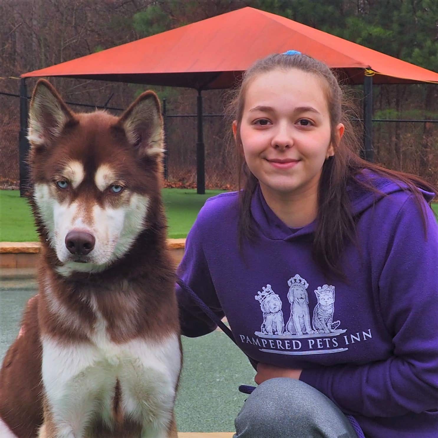 Staff member posing with a dog