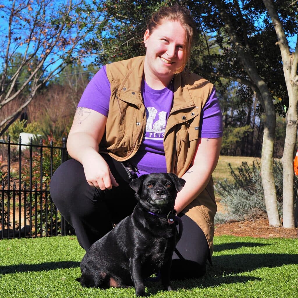 Megan posing with a dog