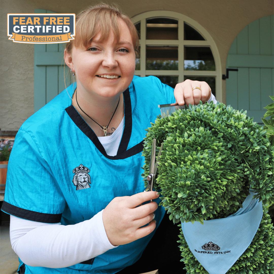Spa Supervisor posing with a topiary of a dog