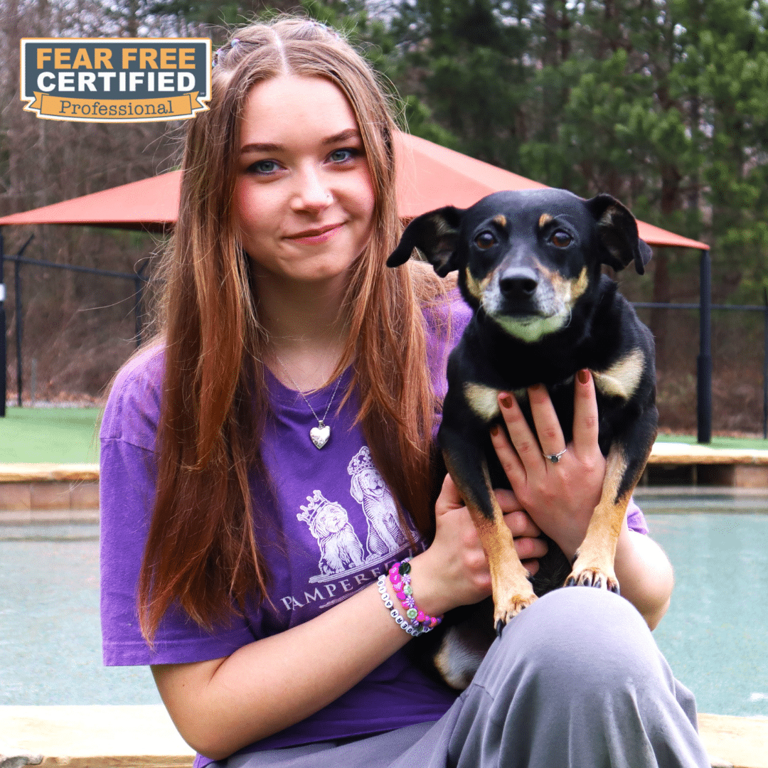 Spa lead posing with a dog on her knee