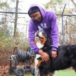 Staff petting a dog guest