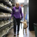 Dog Trainer walking a guest around the facility