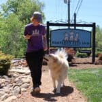 Trainer walking a training dog on a path