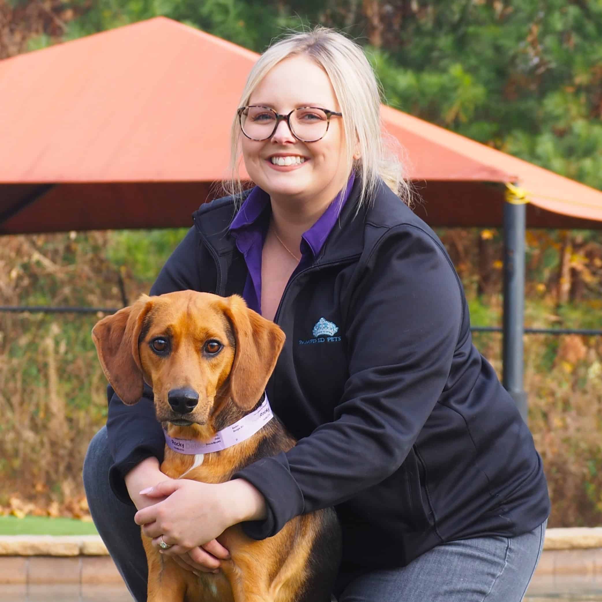 Staff posing with a dog