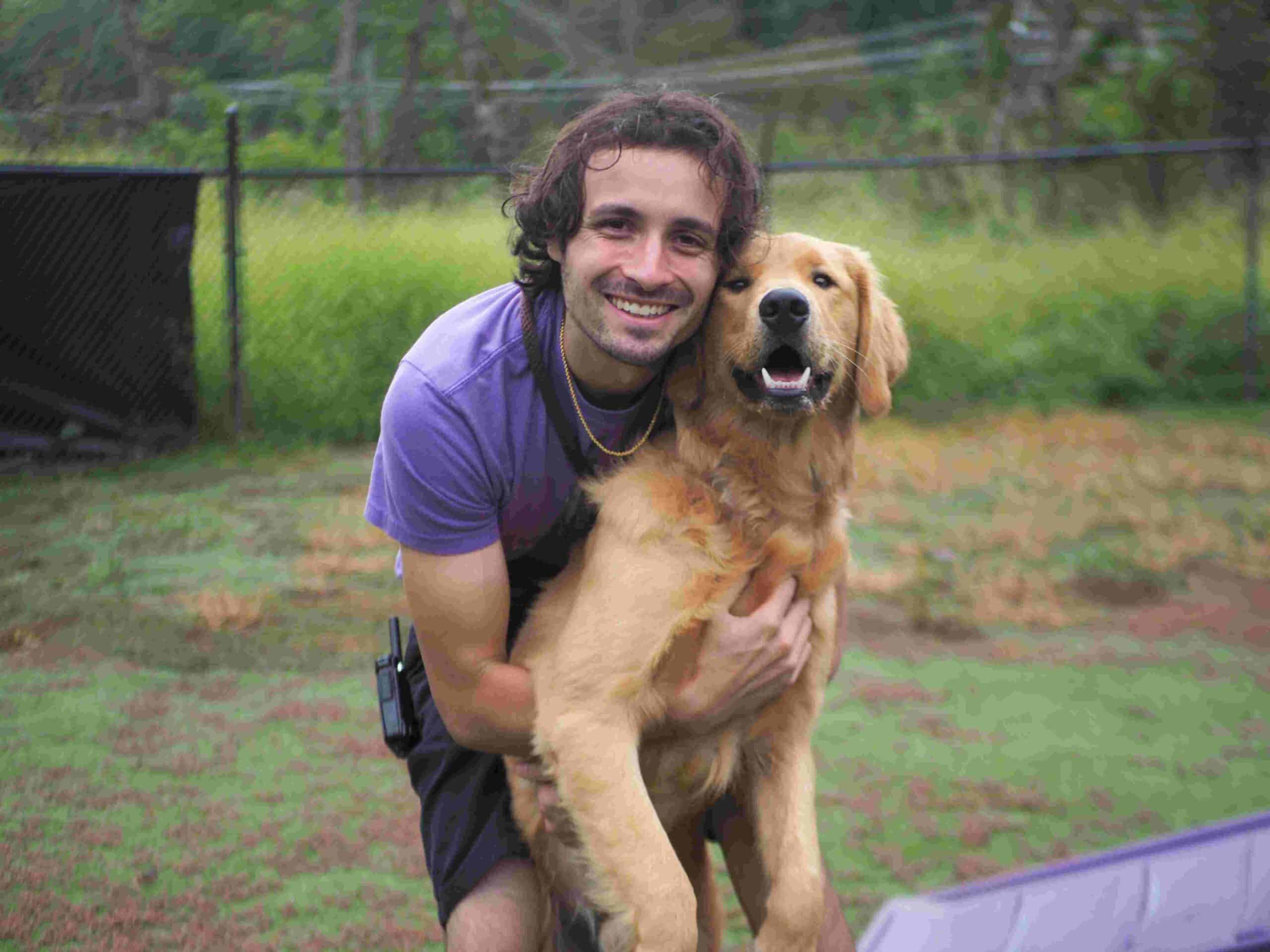 Pet Handler hugging golden retriever