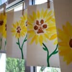 Flower paw paintings hanging in the window